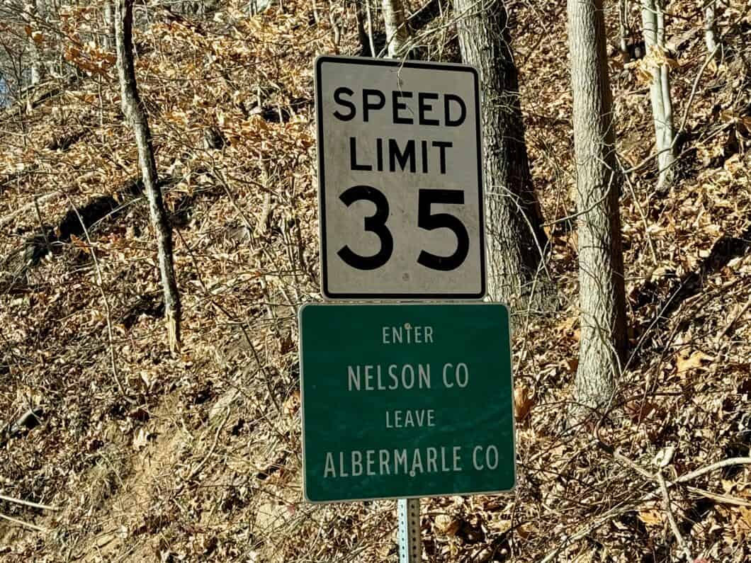 white sign that reads "Speed Limit 35" atop a green sign that says "Enter Nelson Co Leave Albermarle Co" "Albemarle" is misspelled.