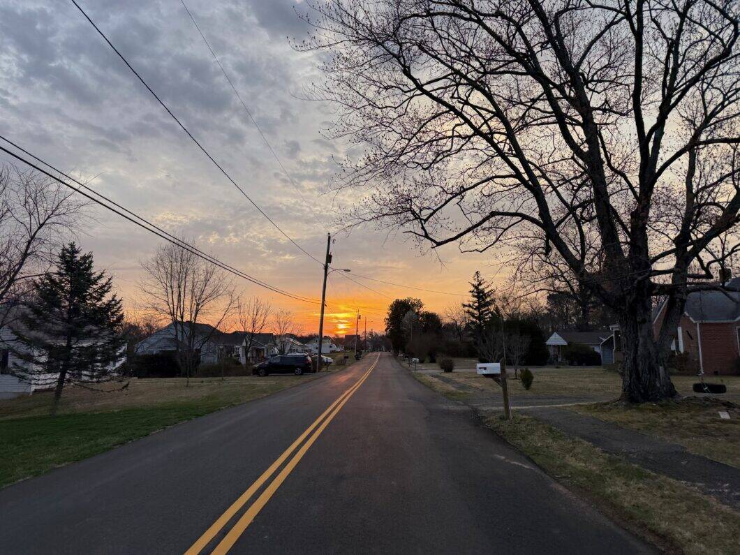 Thinking on my ride home that I am grateful that we are not being bombed. Sunrise over the road with a yellow stripe