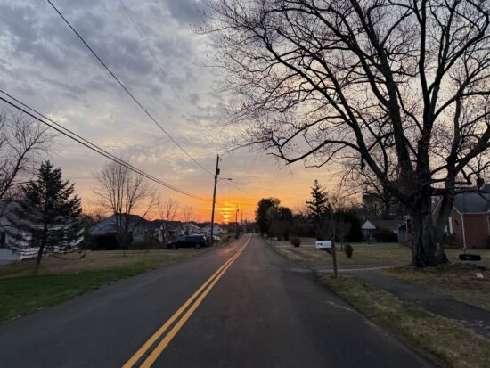 Thinking on my ride home that I am grateful that we are not being bombed. Sunrise over the road with a yellow stripe