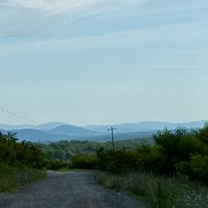 Distant mountains, seen from a gravel road on a solo bike ride